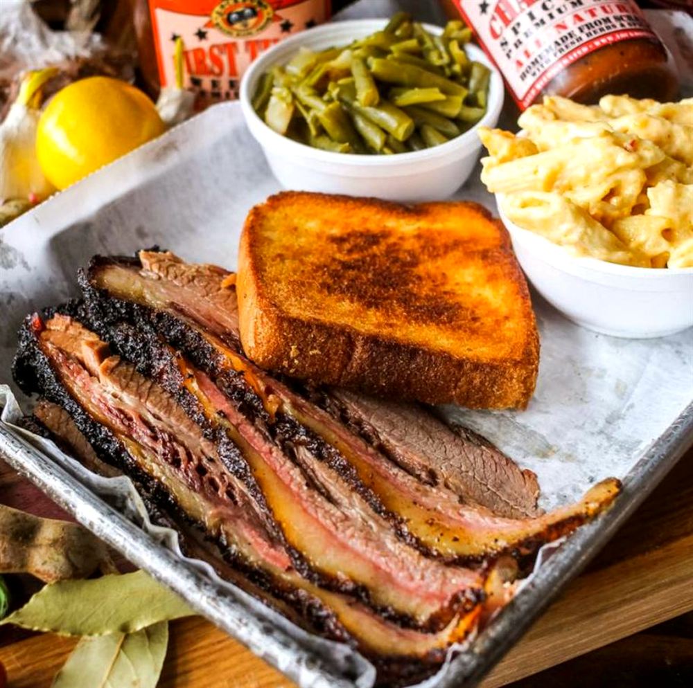 Sliced smoked brisket with Texas toast, green beans and mac and cheese
