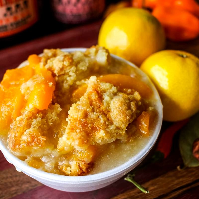 A bowl of homemade peach cobbler